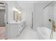 Primary bathroom with a dual sink vanity, a walk-in shower, and a soaking tub at 4017 Mebane Oaks Rd, Mebane, NC 27302