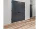 Interior doors with dark grey finish, white trim, and wood-look floors at 4017 Mebane Oaks Rd, Mebane, NC 27302