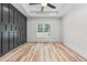 Bedroom featuring a decorative black accent wall, tray ceiling, and ceiling fan at 4017 Mebane Oaks Rd, Mebane, NC 27302