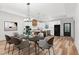 Open-concept dining room with modern lighting, seamlessly connected to a stylish kitchen, creating a perfect entertaining space at 4017 Mebane Oaks Rd, Mebane, NC 27302