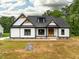 Charming single-Gathering home boasts a modern farmhouse design and inviting front porch at 4017 Mebane Oaks Rd, Mebane, NC 27302