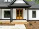 Stunning front entrance featuring wooden double doors, black trim accents, and a well-manicured walkway at 4017 Mebane Oaks Rd, Mebane, NC 27302