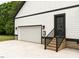 Spacious garage with a white door, black trim, and brick accents, providing convenient access and curb appeal at 4017 Mebane Oaks Rd, Mebane, NC 27302
