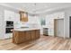 Spacious kitchen features a large island, white cabinets, and stainless steel appliances at 4017 Mebane Oaks Rd, Mebane, NC 27302