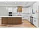 This gourmet kitchen features a large center island, stainless appliances, and a stylish range hood at 4017 Mebane Oaks Rd, Mebane, NC 27302