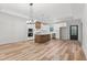 Open kitchen design with large island, stainless appliances, white cabinets, and modern pendant lights at 4017 Mebane Oaks Rd, Mebane, NC 27302