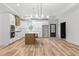 Gourmet kitchen features a center island, modern light fixtures, stainless appliances, and white cabinets at 4017 Mebane Oaks Rd, Mebane, NC 27302