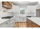 Bright kitchen design with modern fixtures, white subway tile backsplash, and stainless steel appliances at 4017 Mebane Oaks Rd, Mebane, NC 27302