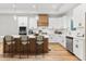 Bright kitchen with white cabinets, stainless steel appliances, and a large center island with bar stool seating at 4017 Mebane Oaks Rd, Mebane, NC 27302