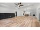 Spacious living room featuring sleek furniture and hardwood floors, leading to the kitchen at 4017 Mebane Oaks Rd, Mebane, NC 27302