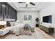 Serene main bedroom with wood accent wall, tray ceiling, natural light, and modern furnishings at 4017 Mebane Oaks Rd, Mebane, NC 27302