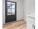 Mud room with exterior access, washer/dryer hookups, and modern white cabinetry at 4017 Mebane Oaks Rd, Mebane, NC 27302
