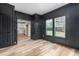 Office with board and batten accent wall leading into the kitchen area at 4017 Mebane Oaks Rd, Mebane, NC 27302