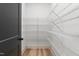 Walk-in pantry with multiple wire shelving units and light wood floors at 4017 Mebane Oaks Rd, Mebane, NC 27302