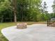 Enjoy outdoor living on this concrete patio featuring a fire pit and easy access to the home at 4017 Mebane Oaks Rd, Mebane, NC 27302