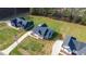 Birds-eye view of three craftsman style homes with black roofs, set on expansive, green lots with long driveways at 4037 Mebane Oaks Rd, Mebane, NC 27302