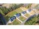 High-angle shot of homes in the area, emphasizing the tidy yards and the nearby wooded areas at 4037 Mebane Oaks Rd, Mebane, NC 27302