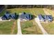 An aerial view showcases three modern homes on large plots of land, accented by long driveways and trees at 4037 Mebane Oaks Rd, Mebane, NC 27302