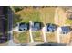 Drone's-eye view of the neighborhood properties, noting the expansive lawns and proximity to roads at 4037 Mebane Oaks Rd, Mebane, NC 27302
