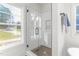 Modern bathroom featuring a glass shower with subway tile and a window to the outside at 4037 Mebane Oaks Rd, Mebane, NC 27302