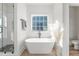 Luxurious bathroom features a soaking tub, glass shower, and modern fixtures at 4037 Mebane Oaks Rd, Mebane, NC 27302