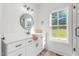 Bright bathroom featuring a modern vanity with stylish fixtures and ample natural light at 4037 Mebane Oaks Rd, Mebane, NC 27302