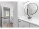 Bathroom with white sink, vanity, black faucet, and round mirror at 4037 Mebane Oaks Rd, Mebane, NC 27302