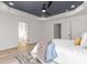 Bright bedroom with a tray ceiling and large windows providing natural light and closet at 4037 Mebane Oaks Rd, Mebane, NC 27302