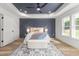 Serene bedroom with a tray ceiling, a statement wall, plush rug and ample natural light at 4037 Mebane Oaks Rd, Mebane, NC 27302