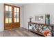 Welcoming foyer with a wooden front door, hardwood floors, and a stylish console table with a mirror at 4037 Mebane Oaks Rd, Mebane, NC 27302