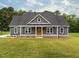 Charming single-story home with gray siding, a welcoming front porch, and a well-maintained lawn at 4037 Mebane Oaks Rd, Mebane, NC 27302