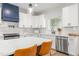 Modern kitchen with a center island, white cabinets, stainless steel appliances and stylish pendant lighting at 4037 Mebane Oaks Rd, Mebane, NC 27302