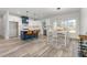 Modern kitchen features a center island with seating, stainless steel appliances, and an adjacent dining area at 4037 Mebane Oaks Rd, Mebane, NC 27302