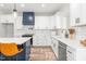 Stylish kitchen showcasing white cabinets, subway tile backsplash, stainless steel appliances, and a center island at 4037 Mebane Oaks Rd, Mebane, NC 27302