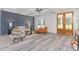 Open-concept living room with fireplace, hardwood floors, and double front doors at 4037 Mebane Oaks Rd, Mebane, NC 27302