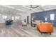 Open-concept living area with a modern kitchen, dining space, and a comfortable seating area with a stylish accent wall at 4037 Mebane Oaks Rd, Mebane, NC 27302