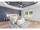 Spacious main bedroom with decorative accent wall, tray ceiling, and large windows at 4037 Mebane Oaks Rd, Mebane, NC 27302