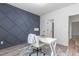 Office with grey accent wall, white desk, white chair, lamp, and stylish rug at 4037 Mebane Oaks Rd, Mebane, NC 27302