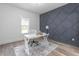 Bright office with a white desk, chair, stylish rug, and decorative gray accent wall at 4037 Mebane Oaks Rd, Mebane, NC 27302