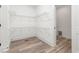 Spacious walk-in closet with wood-style flooring and wire shelving at 4037 Mebane Oaks Rd, Mebane, NC 27302