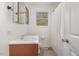 Bright bathroom featuring a window, white vanity, and a shower with a white curtain at 424 S Greensboro St, Carrboro, NC 27510