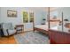 Sunlit bedroom with a four-poster bed, classic chair and elegant decor at 424 S Greensboro St, Carrboro, NC 27510