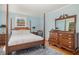 Bedroom featuring four-poster bed, side tables and generous dresser with decorative mirror at 424 S Greensboro St, Carrboro, NC 27510