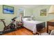 Guest bedroom with exercise equipment, hardwood floors and two windows at 424 S Greensboro St, Carrboro, NC 27510