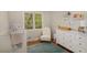 Bright Bedroom with crib, comfortable chair and ample storage at 424 S Greensboro St, Carrboro, NC 27510