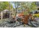 Backyard fire pit area featuring a stone fire pit, seating, and storage shed at 424 S Greensboro St, Carrboro, NC 27510