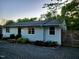 Quaint home featuring a well-manicured lawn, gravel driveway, and lovely landscaping at 424 S Greensboro St, Carrboro, NC 27510