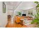 Bright living room features hardwood floors, a stylish leather sofa, and an open floor plan leading to the dining area at 424 S Greensboro St, Carrboro, NC 27510