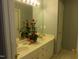 A well lit double sink bathroom with an ample vanity and flower decorations at 4245 Toccopola St, Raleigh, NC 27604