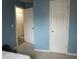 Bedroom featuring a double door closet, bright paint, and carpeted floors at 4245 Toccopola St, Raleigh, NC 27604
